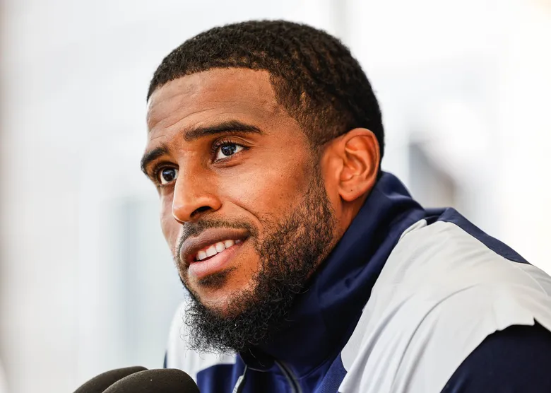 Bobby Wagner proudly holding his new honorary doctorate degree