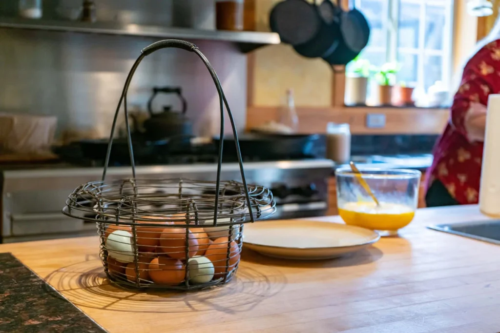 A person safely cooking fresh eggs in a clean home kitchen