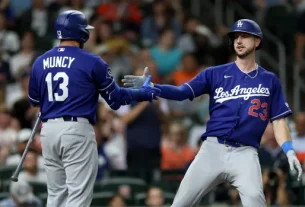 Los Angeles Dodgers players celebrating a play against the Houston Astros
