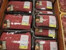 A massive ground beef recall warning notice posted in a local grocery store today
