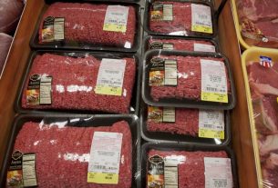 A massive ground beef recall warning notice posted in a local grocery store today