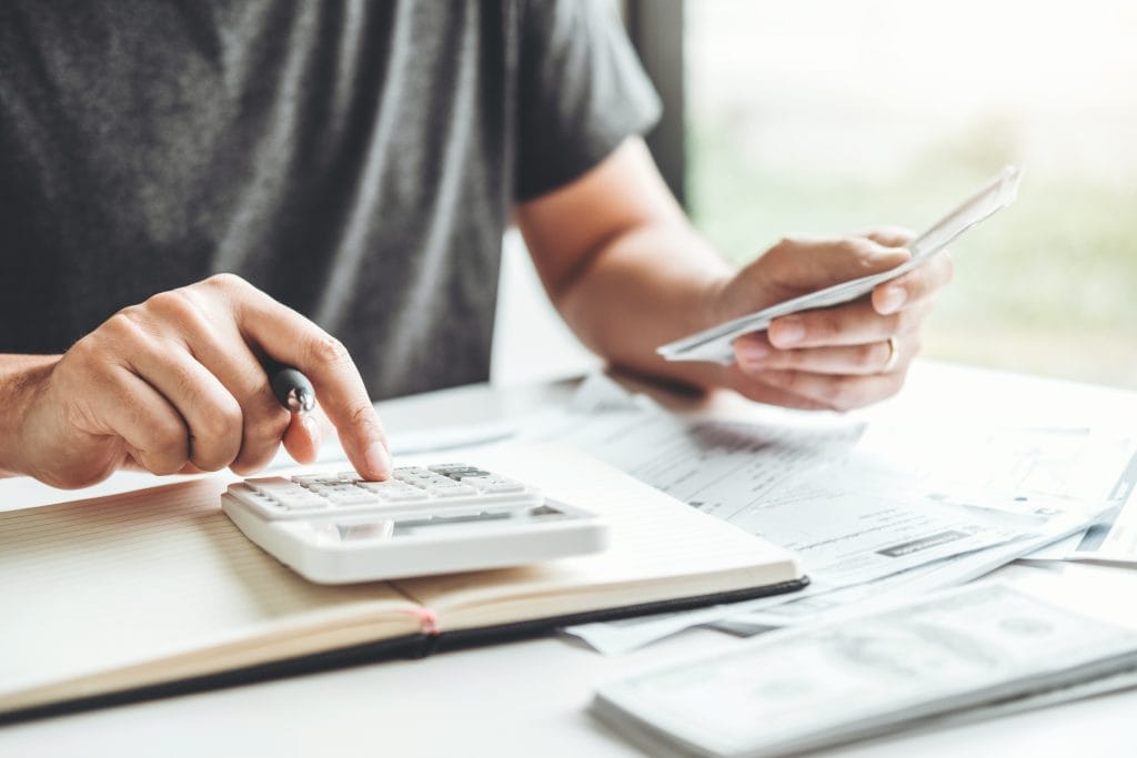 A professional accountant calculating tax refunds on a calculator