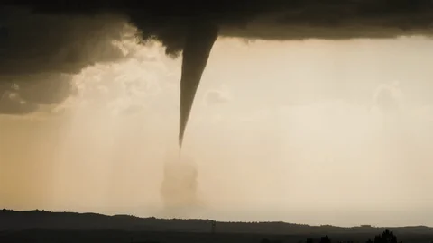 A massive dark tornado outbreak warning storm approaching a rural town