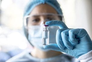 A professional doctor holding a medical vial during the bird flu warning
