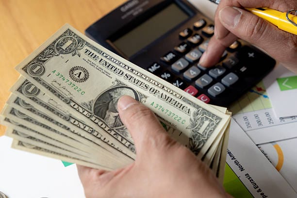 US dollar bills on a table representing the Social Security increase payment
