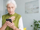 A worried senior citizen receiving a fake call about a Medicare scam warning