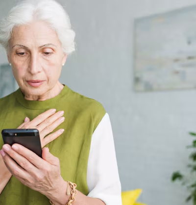 A worried senior citizen receiving a fake call about a Medicare scam warning